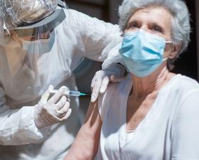 Image of elderly woman receiving COVID-19 vaccine